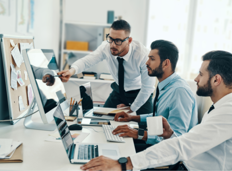 Businessmen analyzing results on computer